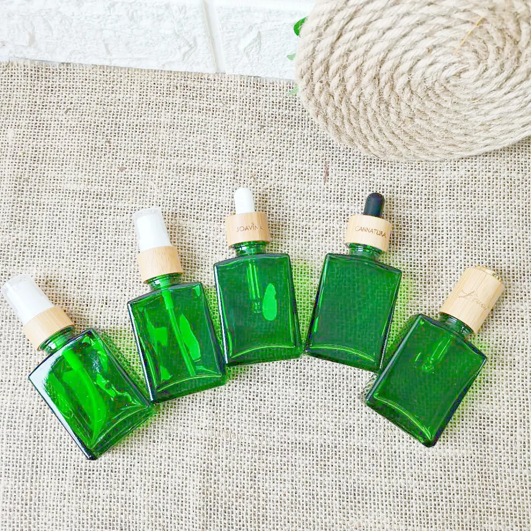 olejek do włosów pomarańczowa buteleczka z zieloną pompką